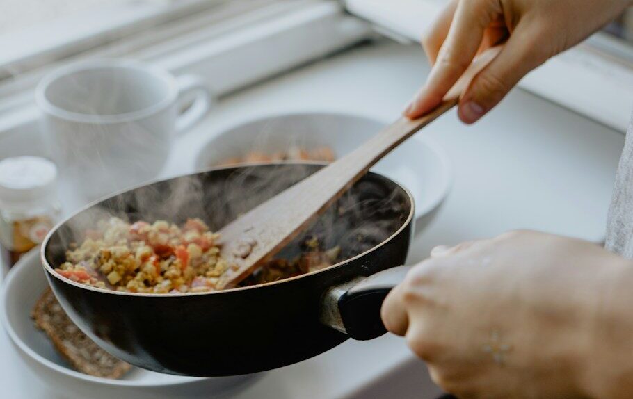 person holding black frying pan