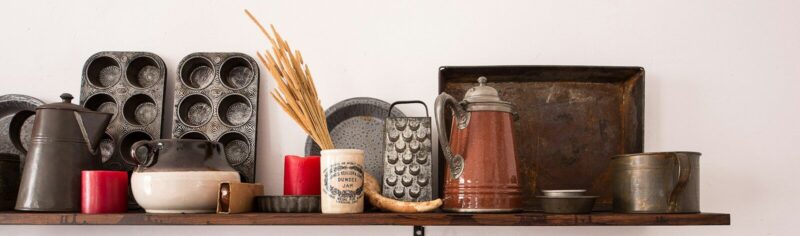 kitchen utensil lot on brown wooden floating shelf