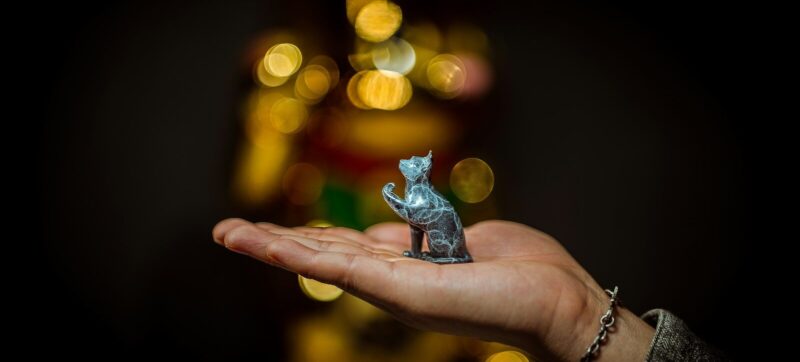 a person holding a small toy animal in their hand