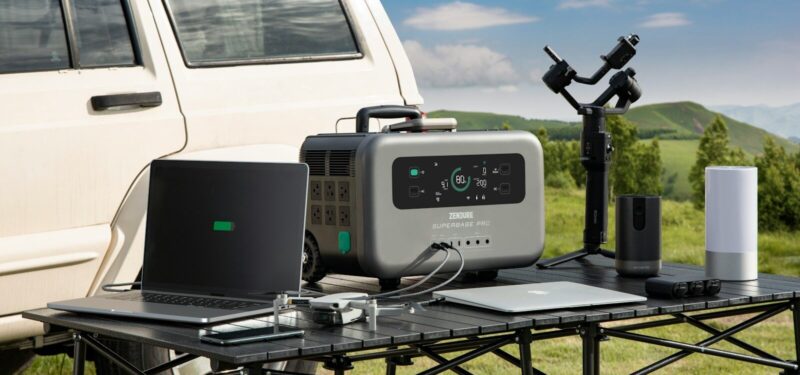 a table with a radio, laptop and other electronics on it
