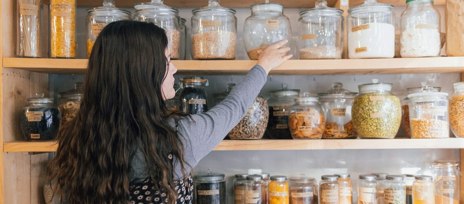 a person holding a jar of food
