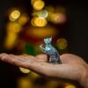 a person holding a small toy animal in their hand